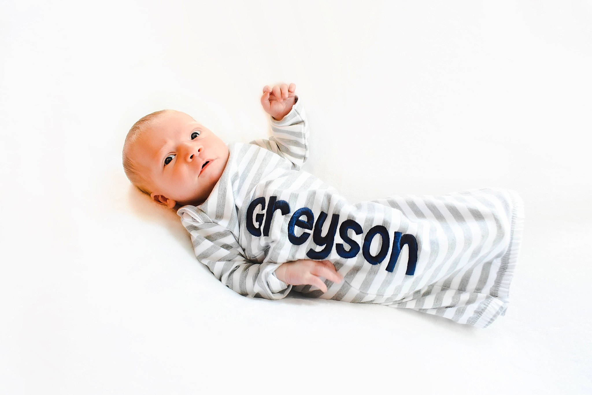 Greyson is registered to the contest to win money with this photo: art, baby, baby_toddler_clothing, brand, child, collar, comfort, flash_photography, font, happy, linens, logo, pattern, person, portrait_photography, sitting, sleeve, smile, t_shirt, toddler