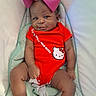 Amari joined the competition — help win amazing prizes! baby, infant, child, onesie, hello_kitty, red_clothing, pink_bow, cushion, seat, smile, face, person, cute, indoors, baby_seat, comfort, young_child, portrait, happy, skin