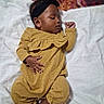 Amari is registered to the contest to win money with this photo: baby, infant, child, sleeping, blanket, headband, yellow_clothing, hands, feet, portrait, indoors, soft_texture, cozy, cute, peaceful, closeup, skin, person, relaxing, lying_down