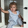 Magnolia joined the competition — help win amazing prizes! toddler, child, cabinet, door, indoor, curious, blue_eyes, patterned_clothing, hair_bow, barefoot, wood_floor, playful, sitting, small_person, furniture, home, exploring, cute, innocent, young_child