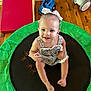 toddler, child, smiling, sitting, indoor, trampoline, toy, dress, bow, floor, wooden_floor, play, happy, face, person, cute, colorful, baby_toy, footwear_free, hair_accessory