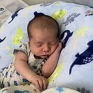 Carter Lee joined the competition — help win amazing prizes! baby, sleeping, blanket, dinosaur_pattern, infant, cozy, cute, resting, soft, child, pajamas, indoor, peaceful, newborn, hand, face, head, comfort, closeup, portrait