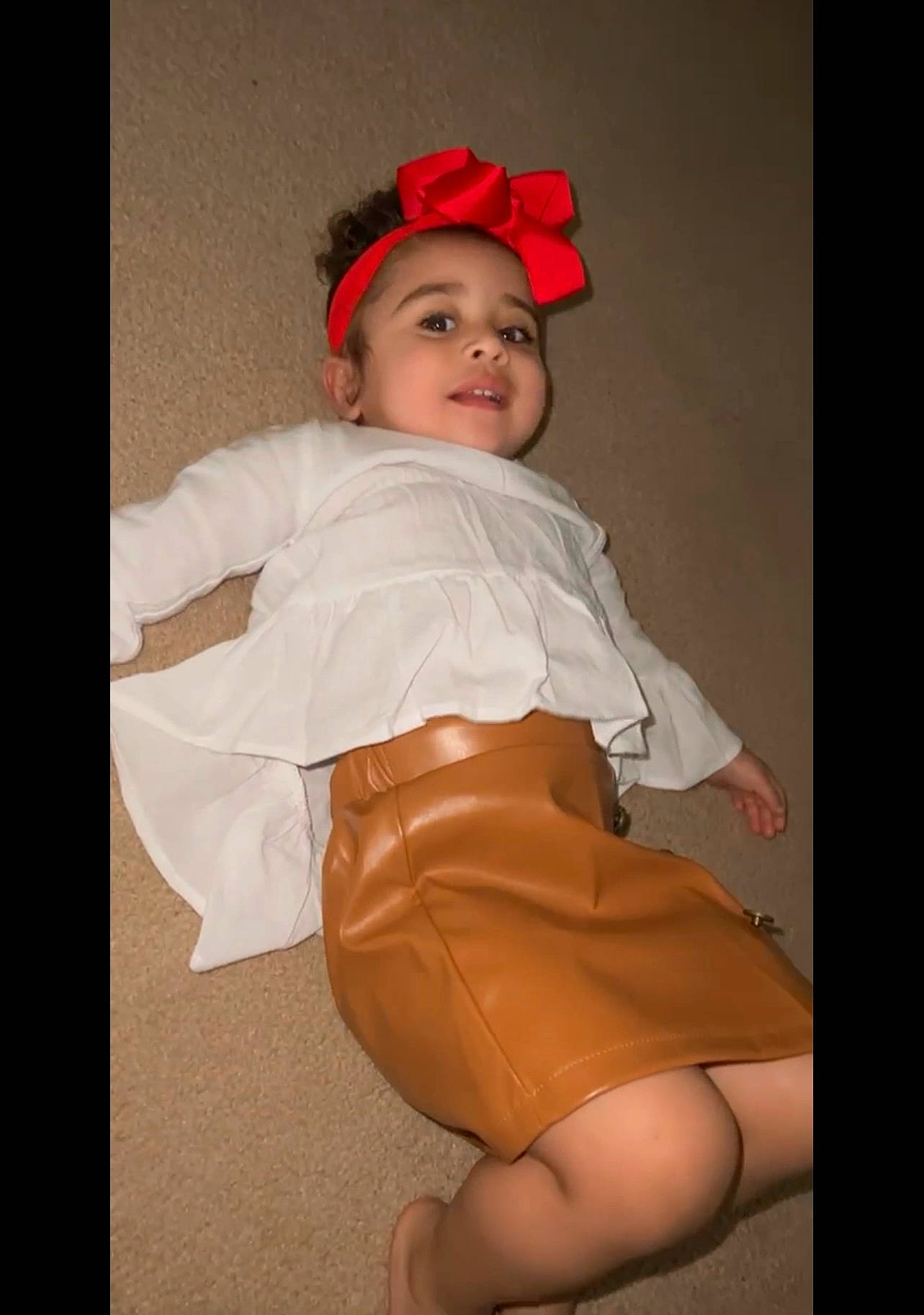 Kehlani is registered to the contest to win money with this photo: baby, baby_toddler_clothing, child, comfort, embellishment, face, flash_photography, happy, headwear, human_leg, knee, lap, leg, pattern, peach, person, sitting, skin, sleeve, smile