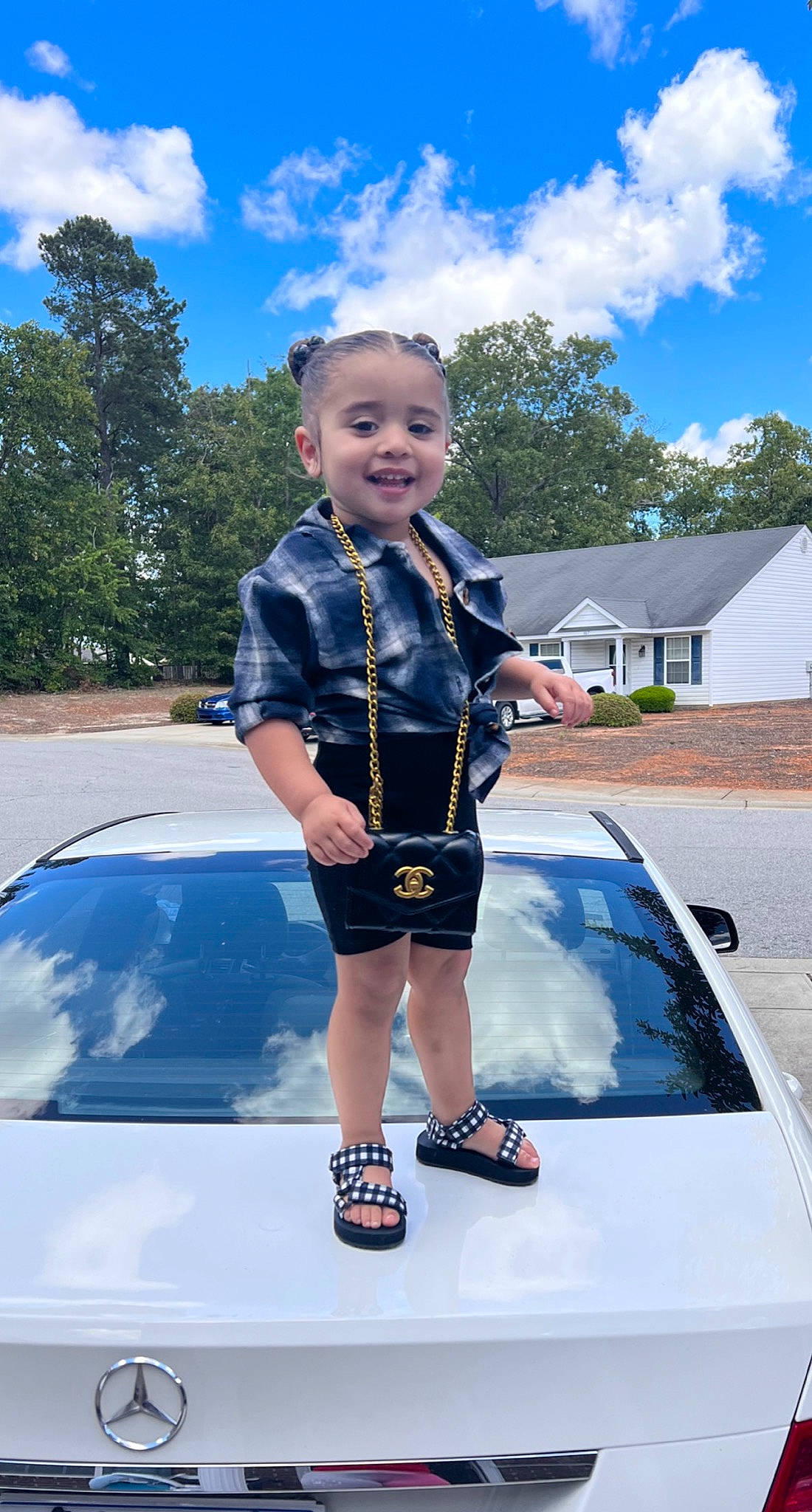 Kehlani joined the competition — help win amazing prizes! automotive_design, automotive_exterior, automotive_lighting, blue, bumper, car, cloud, electric_blue, grass, hood, joy, motor_vehicle, person, personal_luxury_car, plant, sky, smile, toddler, tree, vehicle