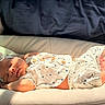baby, sleeping, infant, polka_dot, headband, cushion, blanket, soft_fabric, clothing, foot, hand, face, indoors, sunlight, peaceful, cute, newborn, resting, portrait, comfort