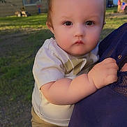 Arlo is registered to the contest to win money with this photo: baby, child, infant, face, expression, hand, skin, clothing, tshirt, shorts, person, outdoor, grass, tree, house, daylight, nature, holding, portrait, cute