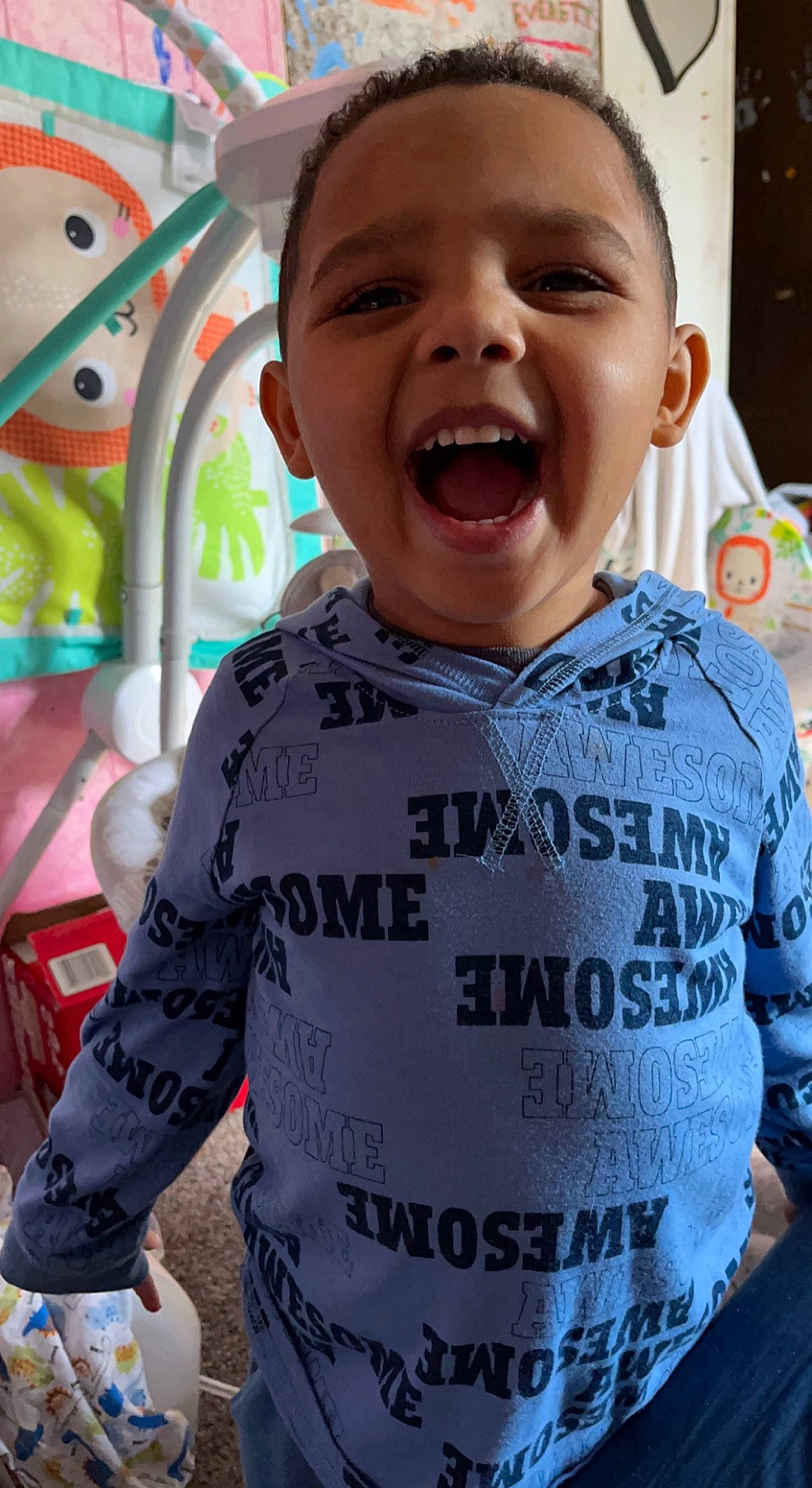 Malcolm is registered to the contest to win money with this photo: baby, baby_toddler_clothing, cheek, child, chin, face, fun, happy, leisure, mouth, neck, nose, organ, person, photograph, product, sleeve, smile, t_shirt, toddler