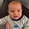 Harry participe au concours pour gagner de l'argent avec cette photo : baby, child, clothing, cozy, cushion, cute, eyes, face, hand, happy, head, indoor, infant, penguin, person, portrait, smile, sweater, warm, young