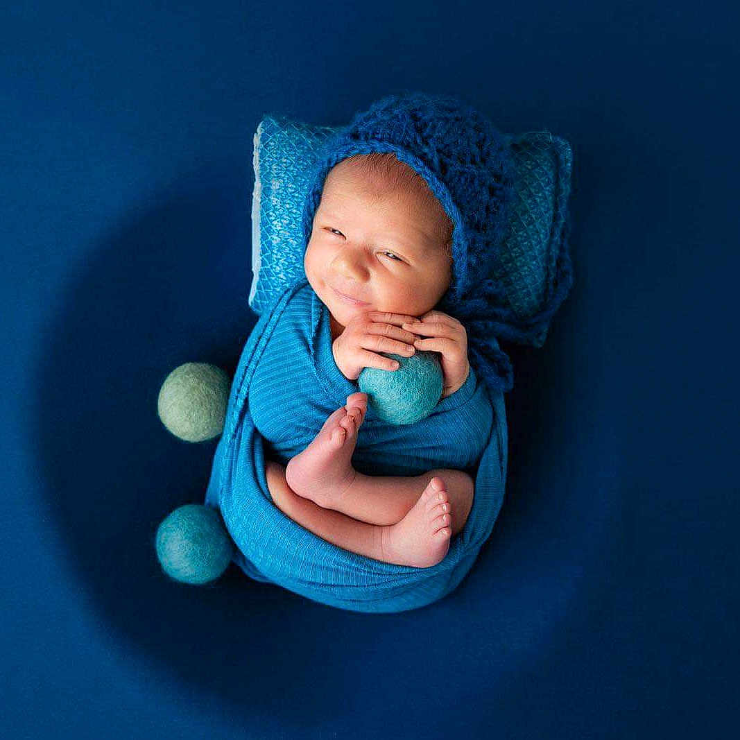 Jordan joined the competition — help win amazing prizes! baby, babylaughing, blanket, bonnet, cap, clothing, face, happy, hat, head, knitwear, newborn, people, person, photography, portrait, sitting, sleeping, smile, sweater