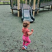 Piper joined the competition — help win amazing prizes! toddler, child, playground, slide, outdoor, play_equipment, railings, green, beige, trees, grass, picnic_bench, overcast, clothing, shoes, walking, park, young_child, play_area, daytime