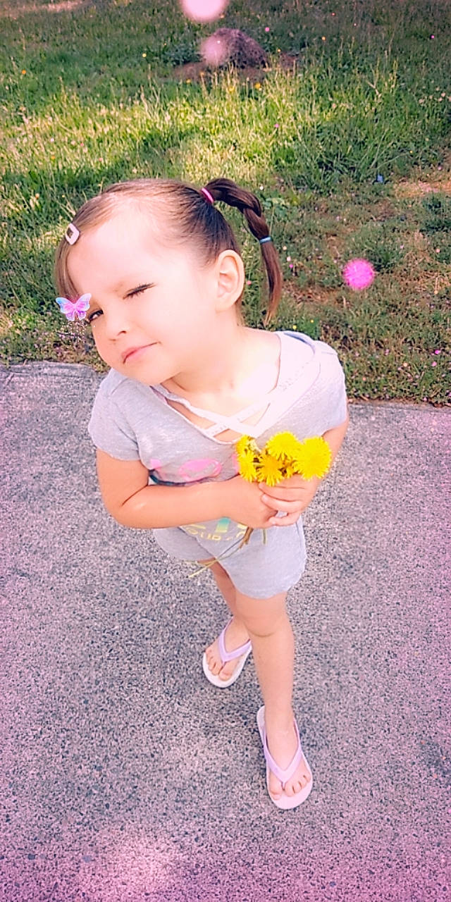 Kayani is registered to the contest to win money with this photo: baby, baby_toddler_clothing, child, costume, flower, footwear, grass, headband, person, pink, plant, play, shoe, skin, smile, toddler