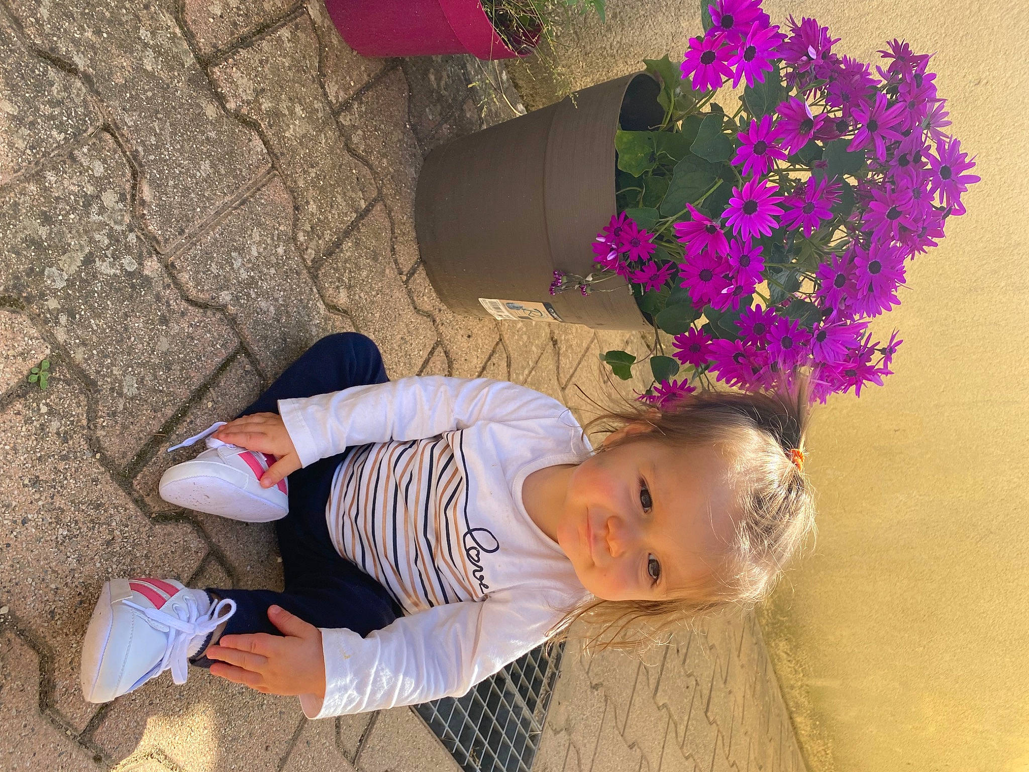 Cléa participe au concours pour gagner de l'argent avec cette photo : clothing, eyewear, flower, flower_arranging, fun, grass, happy, hat, human_leg, leisure, magenta, person, petal, plant, sand, sandal, smile, sunglasses, tints_and_shades, toddler