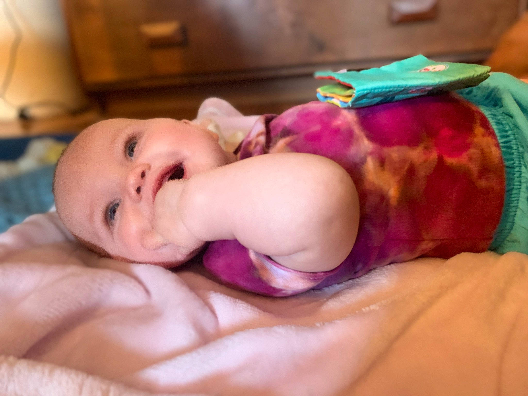 Echo is registered to the contest to win money with this photo: abdomen, baby, baby_toddler_clothing, cheek, chest, child, comfort, fashion_accessory, finger, fun, hair_accessory, happy, headwear, linens, magenta, person, room, skin, sleep, smile