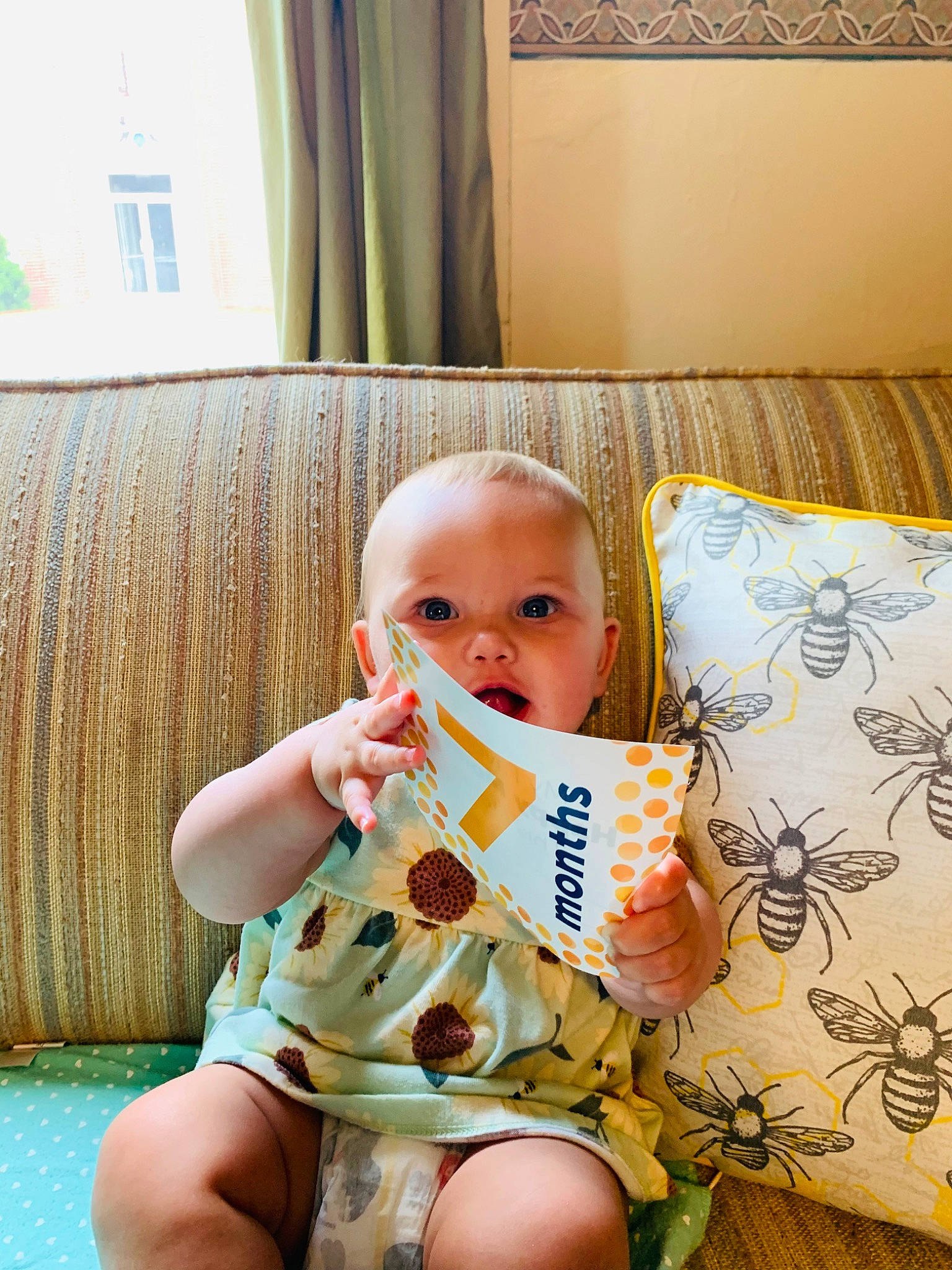 Echo is registered to the contest to win money with this photo: baby, baby_toddler_clothing, child, comfort, couch, curtain, flooring, happy, leisure, linens, living_room, pattern, person, play, room, sitting, textile, thigh, throw_pillow, toddler