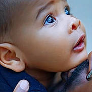 Alusine is registered to the contest to win money with this photo: baby, child, face, eyes, expression, curiosity, portrait, closeup, hand, adult, holding, skin, head, emotion, love, family, person, gentle, touch, intimacy