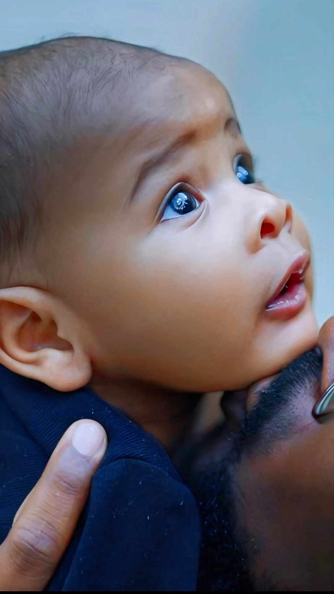 Alusine is registered to the contest to win money with this photo: baby, child, face, eyes, expression, curiosity, portrait, closeup, hand, adult, holding, skin, head, emotion, love, family, person, gentle, touch, intimacy