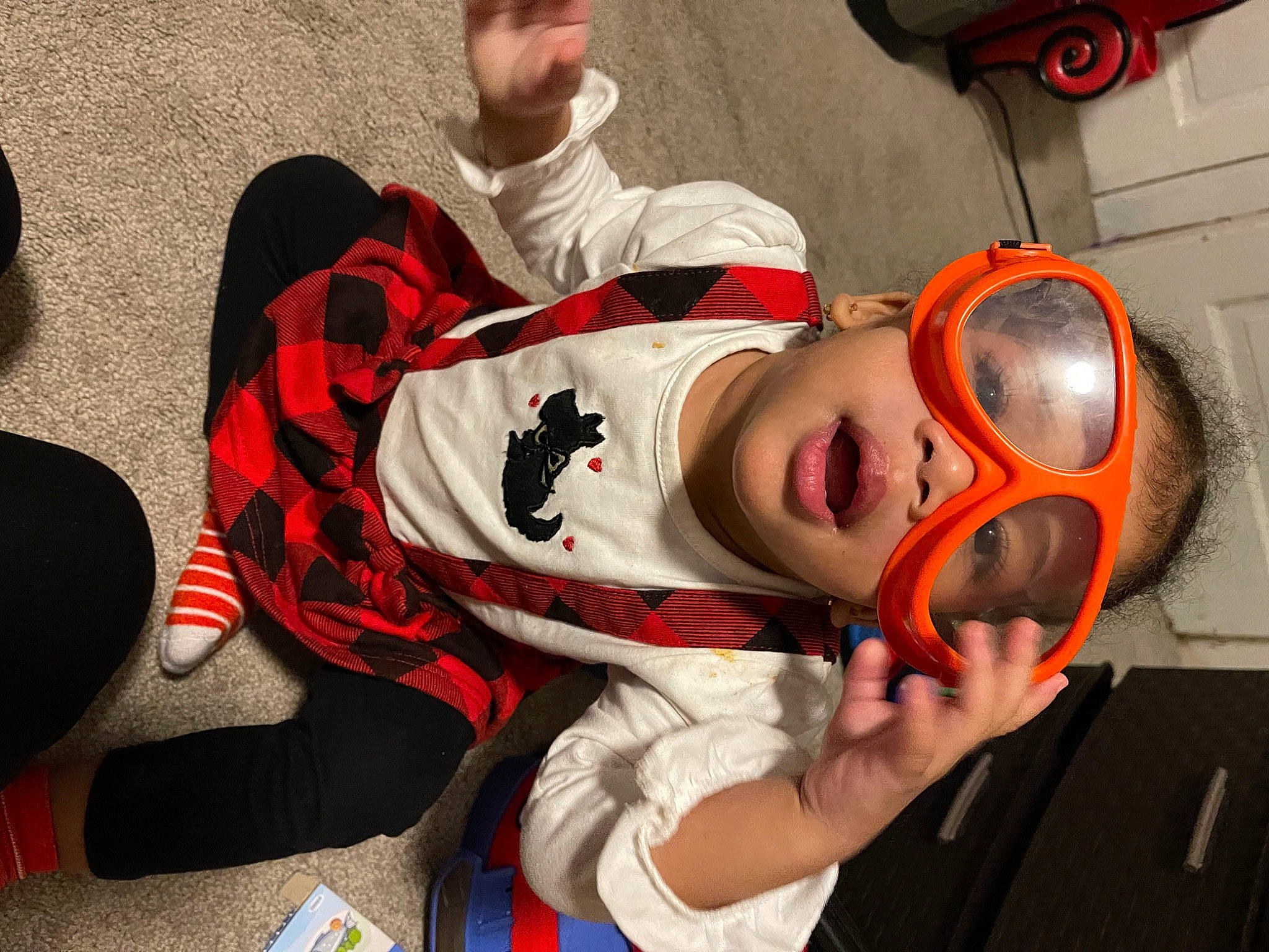Myliyah joined the competition — help win amazing prizes! audio_equipment, baby, baby_toddler_clothing, carmine, child, comfort, costume, event, fictional_character, fun, helmet, mouth, pattern, person, personal_protective_equipment, room, sitting, sports_gear, toddler