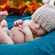 Luca joined the competition — help win amazing prizes! baby, infant, knitted_hat, antlers, blanket, autumn_leaves, outdoor, cute, newborn, child, soft_texture, relaxed, portrait, seasonal, fall, warm_clothing, cozy, skin, small_hands, sleepy