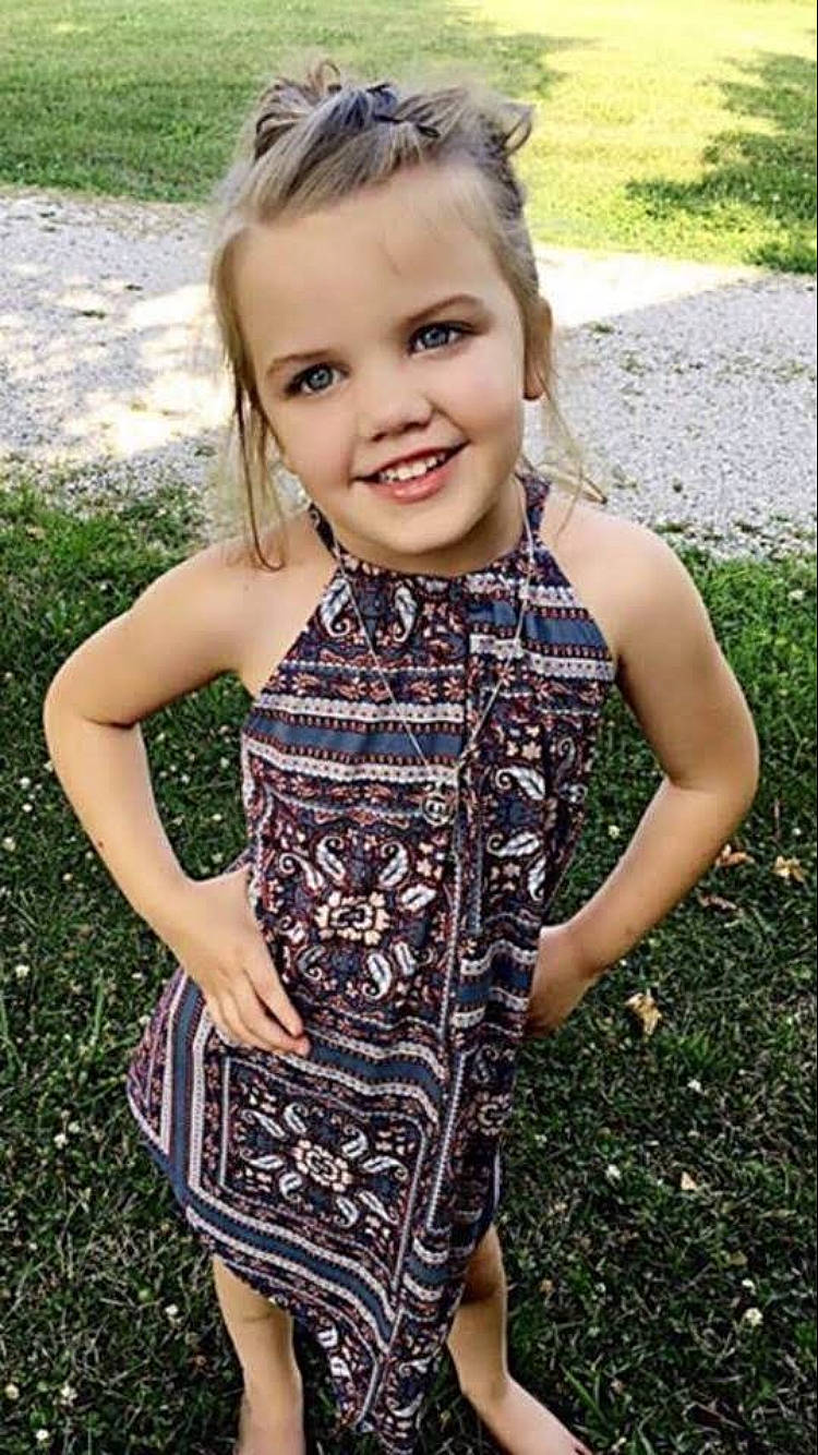 Emma is registered to the contest to win money with this photo: blond, brown, child, child_model, clothing, design, dress, grass, joy, pattern, person, plant, smile, summer, toddler