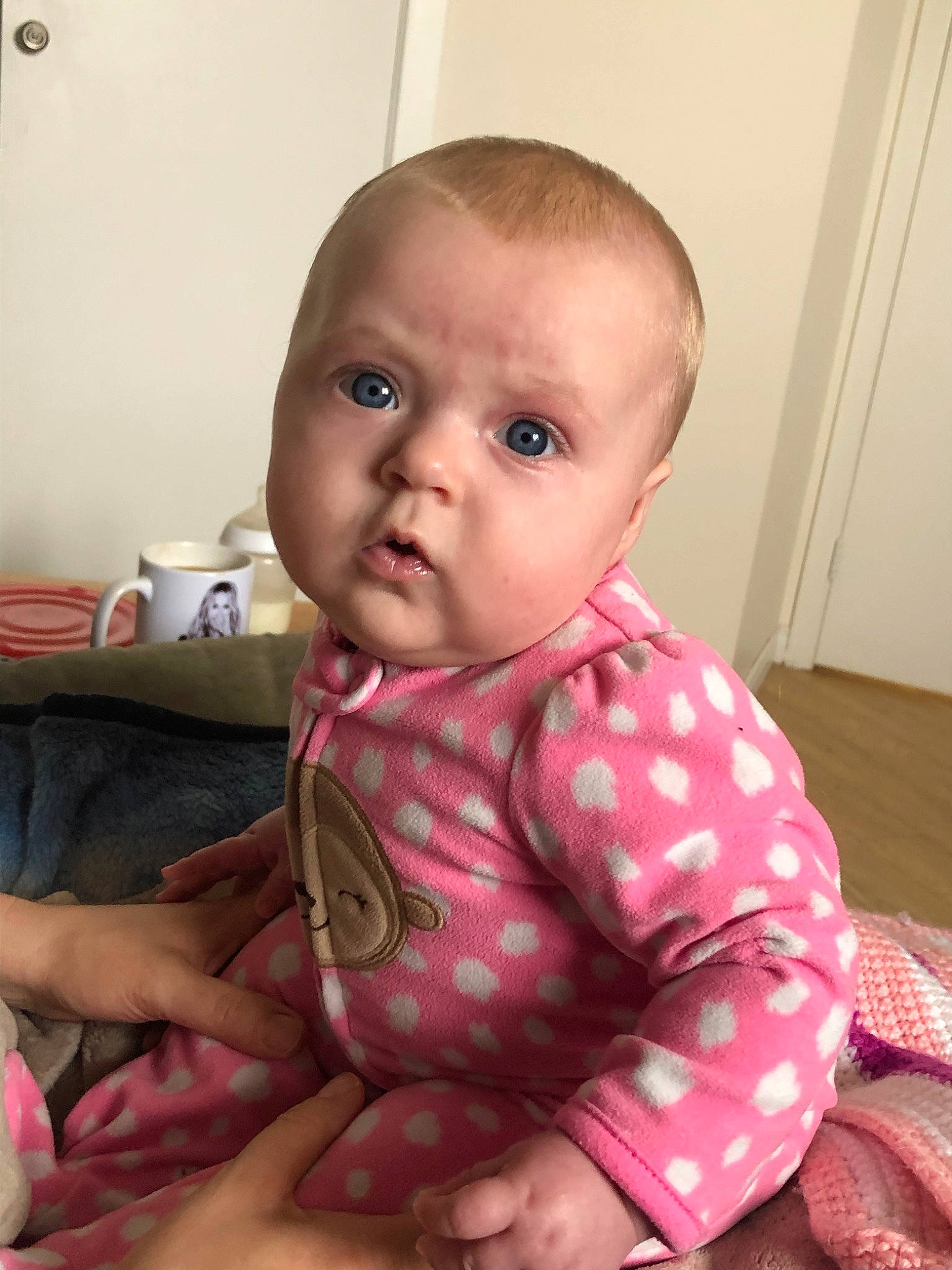 Marjorie participe au concours pour gagner de l'argent avec cette photo : baby, blurred, cheek, child, chin, ear, eye, face, finger, head, iris, lip, mouth, neck, nose, person, pink, sitting, skin, smile