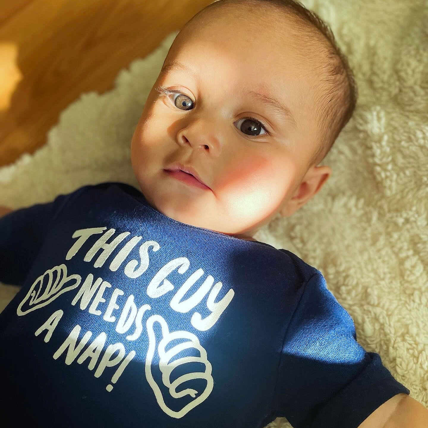 Quinn is registered to the contest to win money with this photo: baby, blonde, clothing, crawling, face, hair, happy, head, newborn, person, photography, portrait, shirt, sitting, skin, sleeve, smile, symbol, t_shirt, text