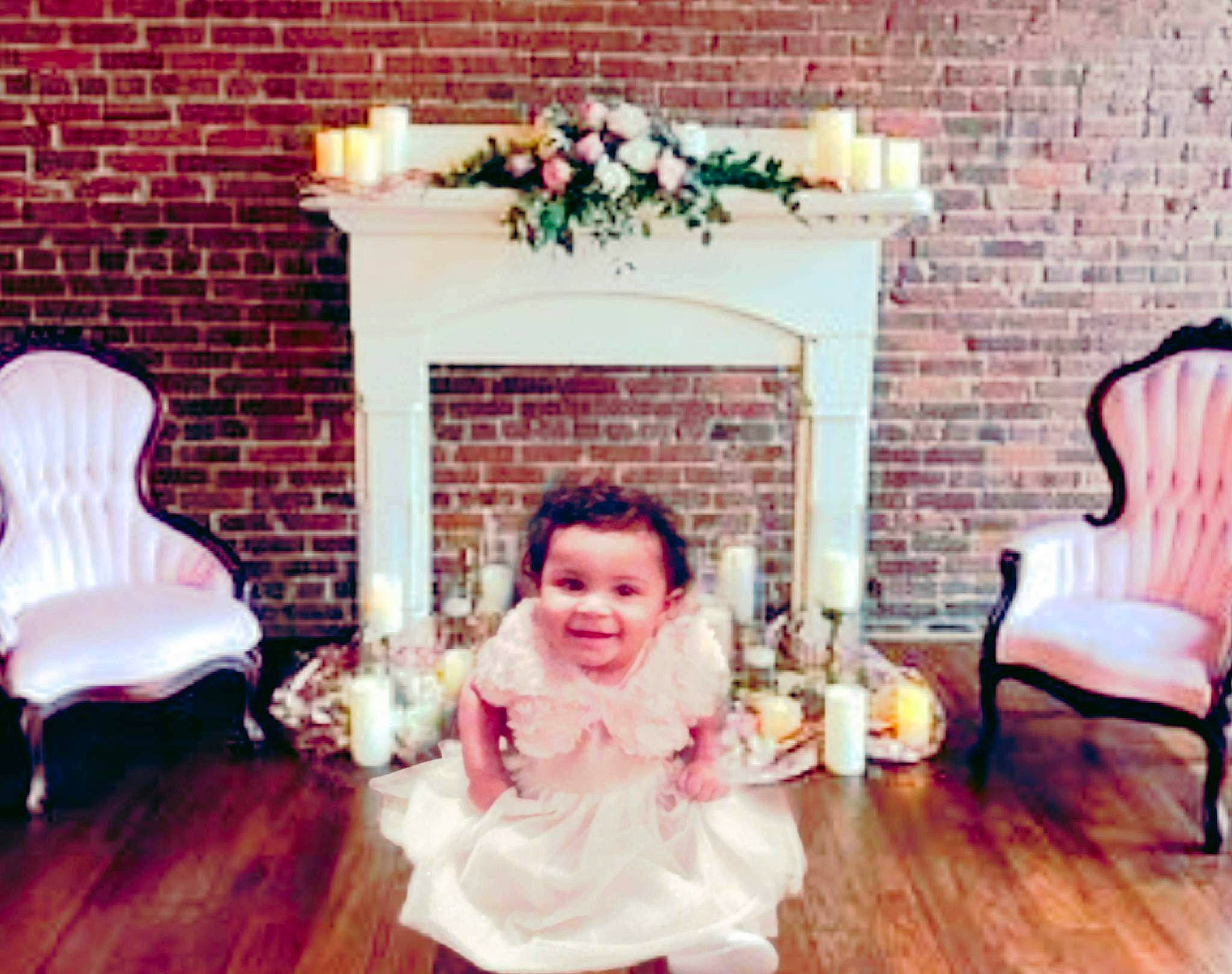 Ky-lea joined the competition — help win amazing prizes! baby, baby_toddler_clothing, brick, brickwork, chair, comfort, event, floor, flooring, furniture, happy, hardwood, hearth, joy, living_room, person, pink, room, sitting, smile