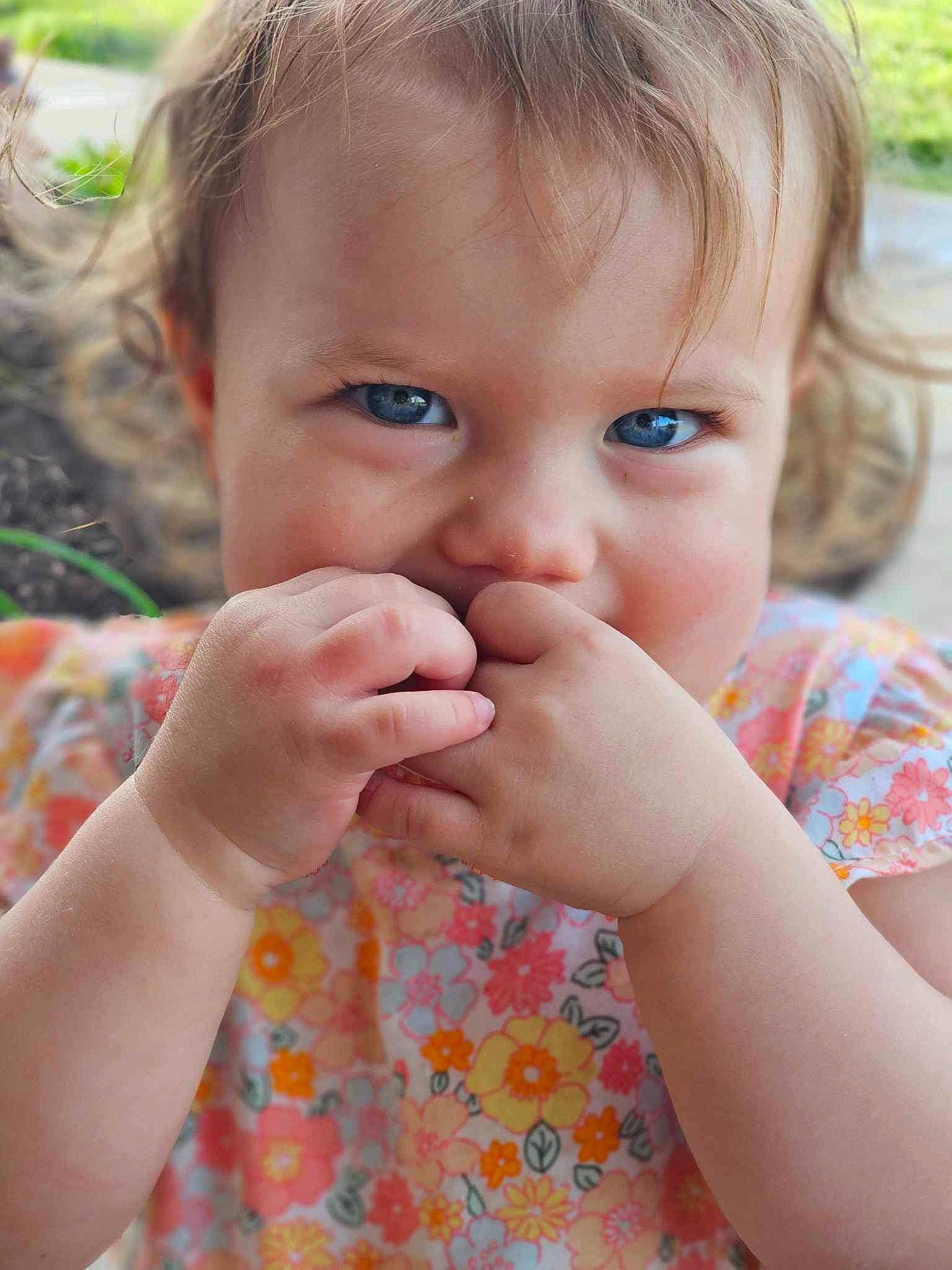Ella is registered to the contest to win money with this photo: baby, baby_toddler_clothing, cheek, child, eyelash, facial_expression, finger, fun, gesture, grass, hand, happy, iris, lip, mouth, nail, nose, person, skin, thumb
