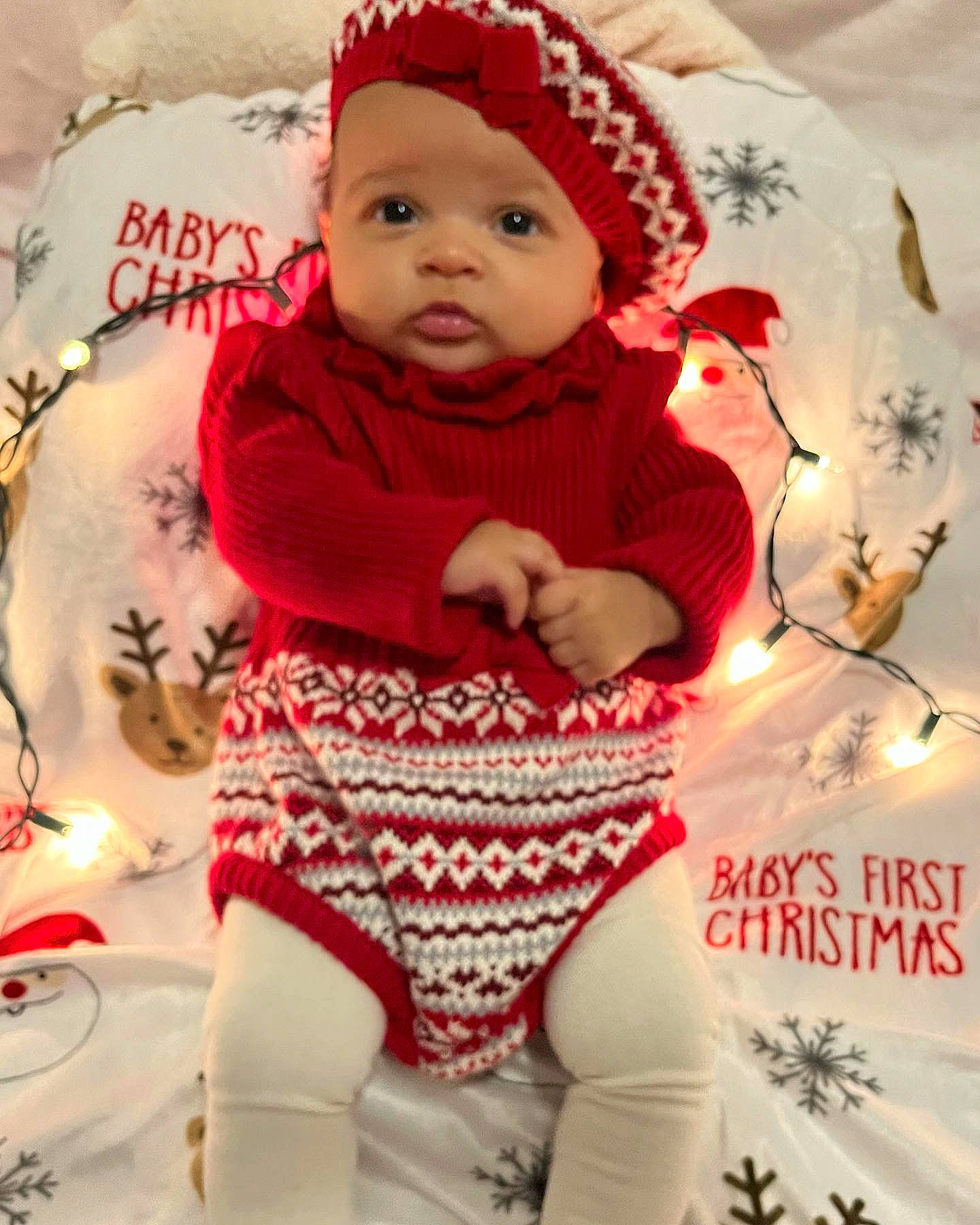 Marianna is registered to the contest to win money with this photo: baby, baby_toddler_clothing, cap, cheek, child, christmas, happy, headgear, headwear, knit_cap, pattern, person, pink, red, skin, sleeve, textile, toddler, white, winter