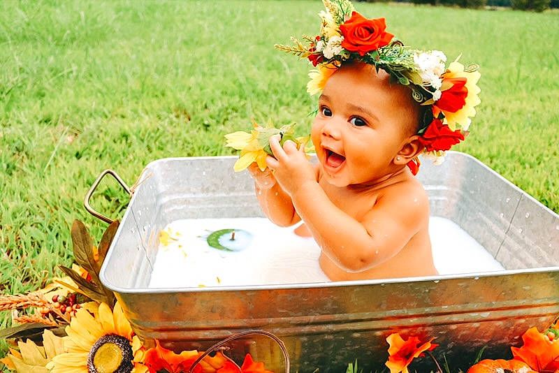 Camille is registered to the contest to win money with this photo: baby, child, fashion_accessory, flower, hair_accessory, happy, headband, orange, person, photography, plant, summer, toddler, yellow