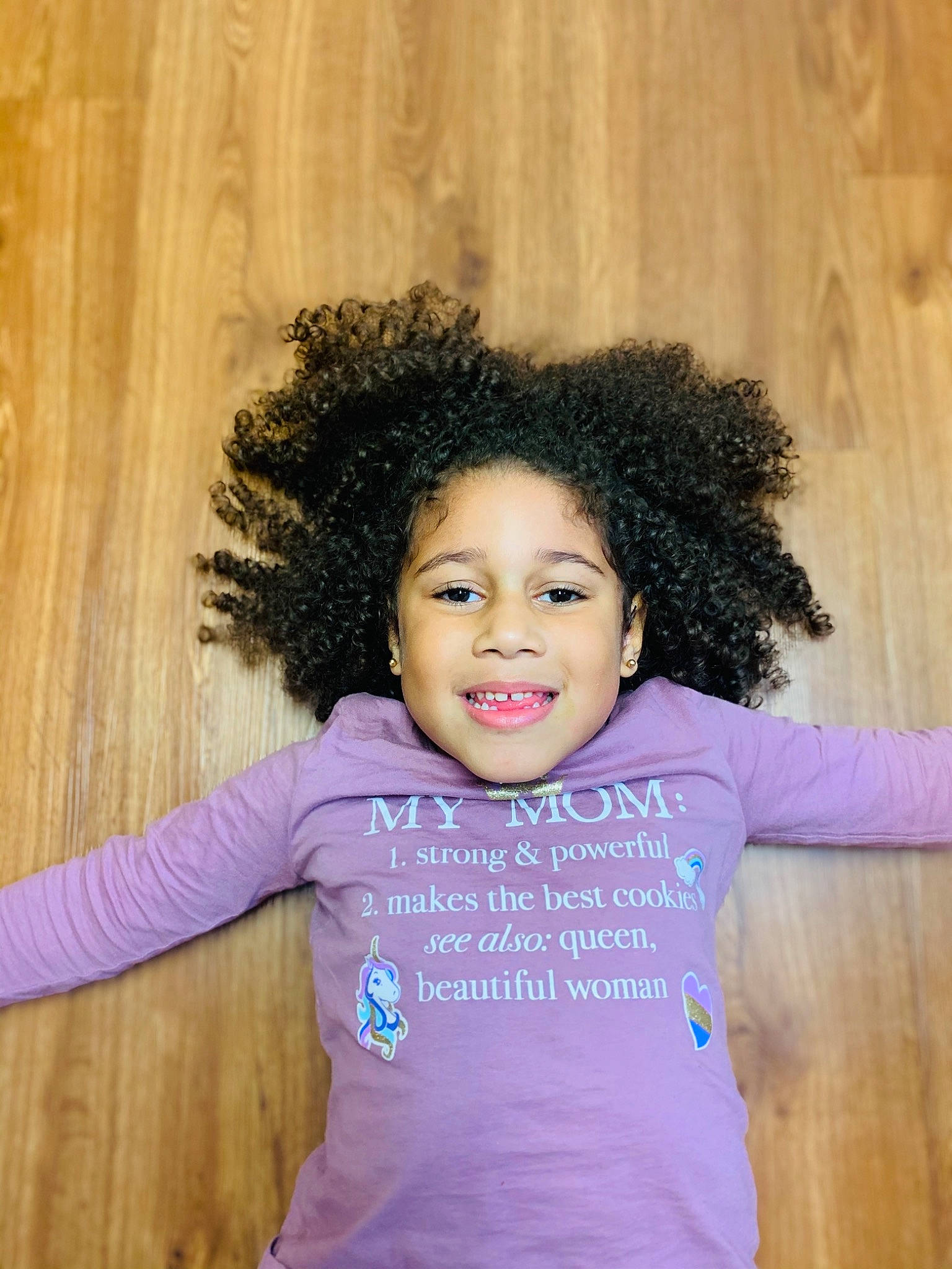 Amiya is registered to the contest to win money with this photo: baby_toddler_clothing, black_hair, cool, hairstyle, happy, iris, jheri_curl, joy, lavender, long_sleeved_t_shirt, magenta, mouth, organ, person, pink, purple, shoulder, sleeve, standing, toddler