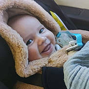 Rayan participe au concours pour gagner de l'argent avec cette photo : baby, child, car_seat, smile, hooded_coat, fluffy, pacifier, infant, seatbelt, car_interior, happy, young_child, warm_clothing, cute, portrait, safety, infancy, toddler, car_window, cozy