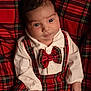 Numa a rejoint le concours — aidez-le/la à gagner de superbes lots ! baby, infant, plaid, red, bow_tie, clothing, blanket, pattern, cute, portrait, small_hands, white_shirt, child, face, eyes, lying_down, soft_lighting, indoors, fabric, cozy