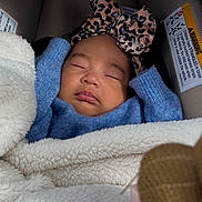 Sienna is registered to the contest to win money with this photo: baby, sleeping, car_seat, headband, leopard_print, blue_sweater, blanket, cozy, infant, child, face, peaceful, indoor, closeup, cute, portrait, resting, soft_texture, warm, bundle