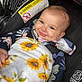 baby, blanket, car, clothing, coat, cushion, dress, face, happy, head, homedecor, jacket, newborn, person, photography, portrait, smile, t_shirt, transportation, vehicle