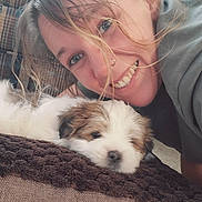 Loki joined the competition — help win amazing prizes! woman, smiling, puppy, dog, pet, indoor, blanket, hair, face, happy, fur, closeup, couch, nose_ring, resting, cozy, friendship, young_adult, casual_clothing, light