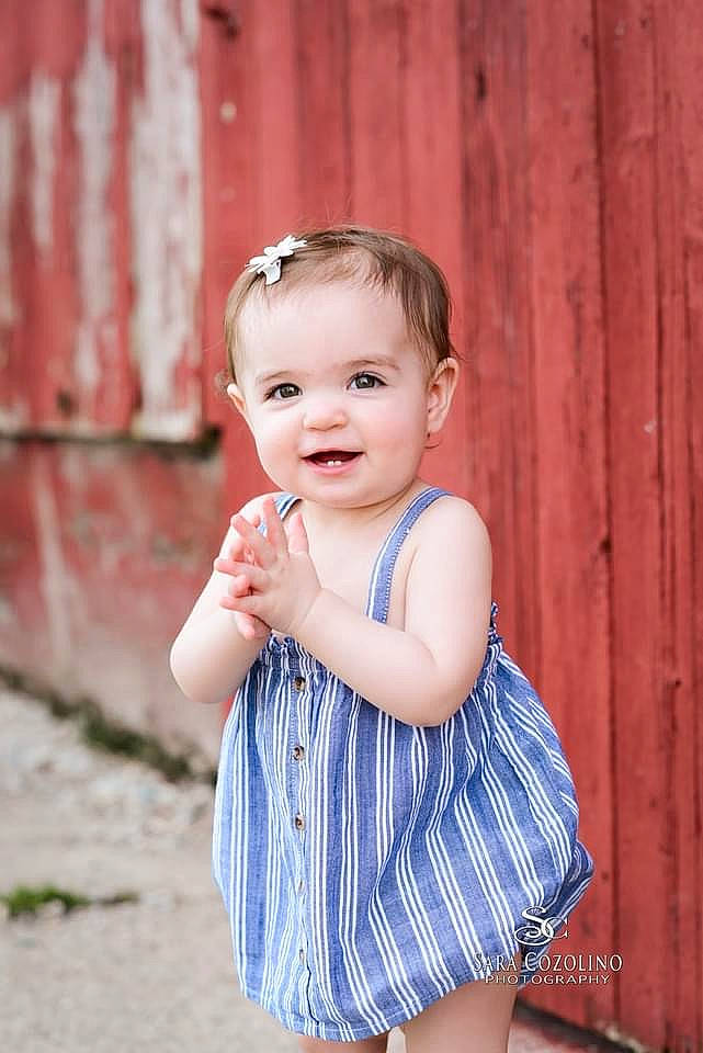 Brooke is registered to the contest to win money with this photo: baby, baby_toddler_clothing, child, day_dress, eye, face, facial_expression, flash_photography, grass, happy, head, iris, joy, one_piece_garment, pattern, person, pink, skin, sleeve, smile