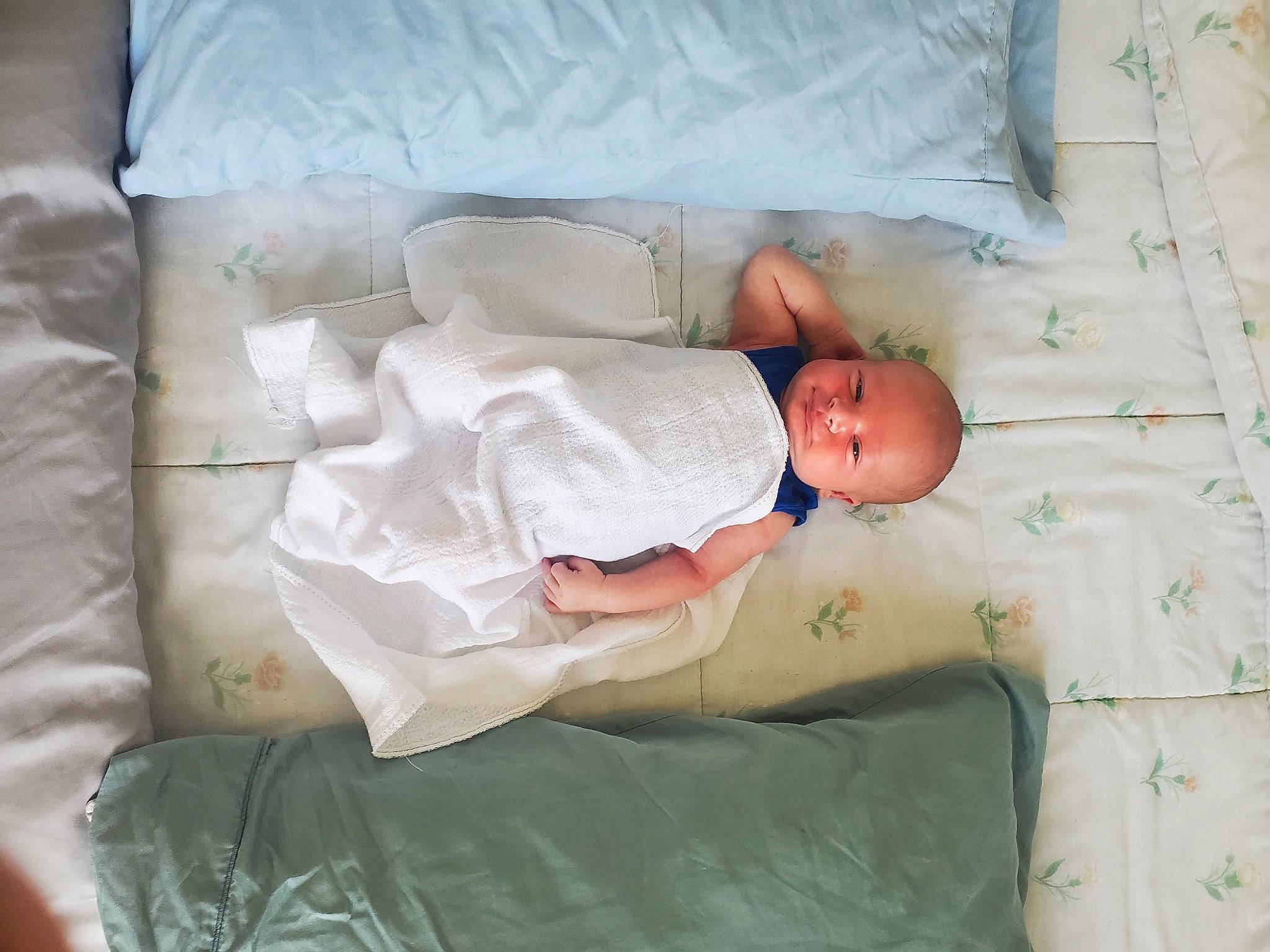 Logan is registered to the contest to win money with this photo: baby, baby_products, baby_safety, baby_toddler_clothing, bed, bedding, bedtime, child, comfort, hand, linens, mammal, pattern, person, room, sleep, sleeve, textile, toddler