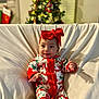 baby, infant, headband, red_bow, christmas_tree, holiday, festive_pajamas, smile, bokeh, living_room, sofa, blanket, cute, portrait, seated, decorations, cozy, holiday_decor, child, family_moment