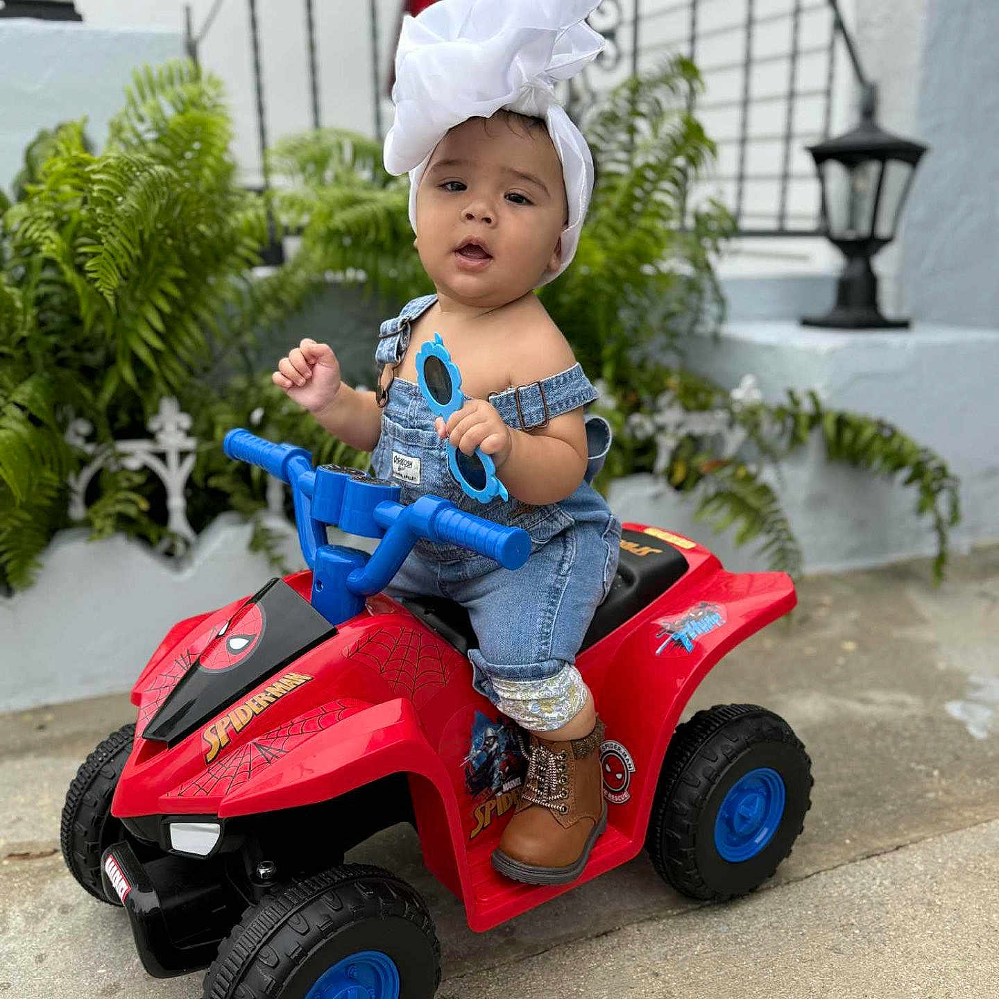 Alendy joined the competition — help win amazing prizes! boots, child, concrete, cute, denim, face, greenery, headwrap, lantern, outdoor, overalls, person, plants, play, quad_bike, spiderman, sunglasses, toddler, toy, wall