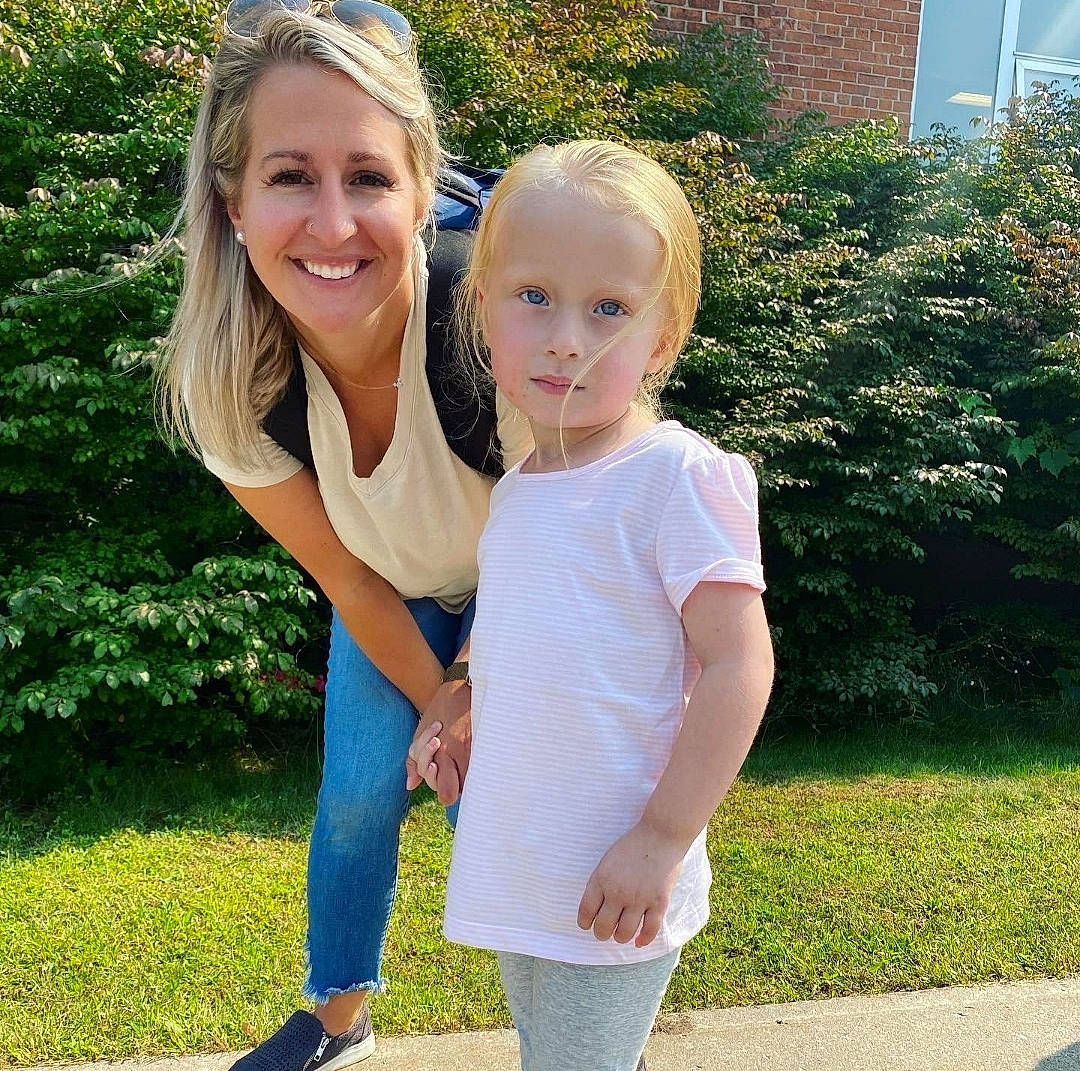 Victoria is registered to the contest to win money with this photo: electric_blue, face, facial_expression, fun, gesture, grass, hair, happy, head, human_body, interaction, joy, leisure, people_in_nature, person, plant, sleeve, smile, sportswear, toddler