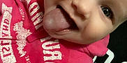 Arya is registered to the contest to win money with this photo: baby, casual, child, close_up, clothing, cute, expression, face, happy, head, hoodie, indoor, person, pink_hoodie, playful, portrait, sitting, smiling, tongue, young