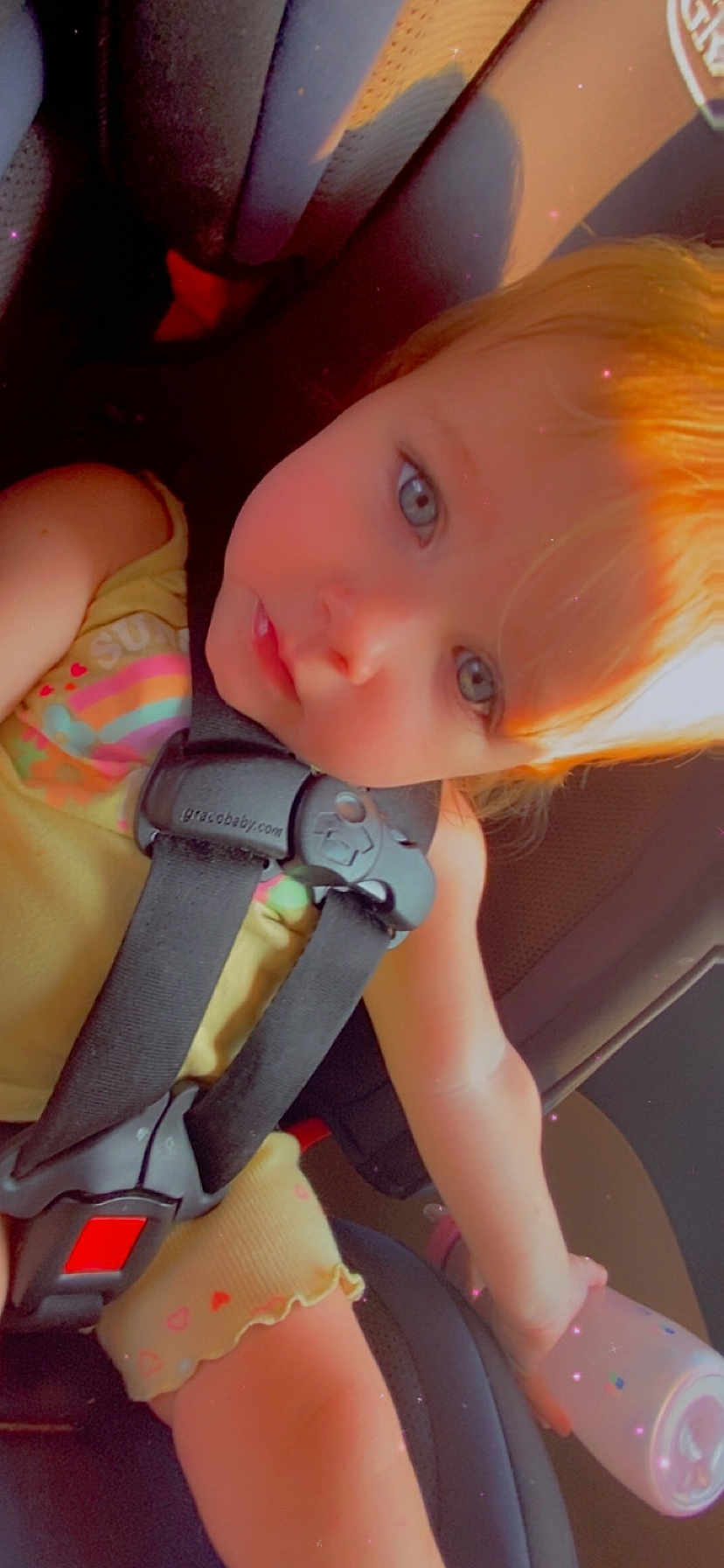Arya joined the competition — help win amazing prizes! toddler, child, car_seat, seatbelt, bottle, yellow_clothing, blue_eyes, light_hair, close_up, sitting, baby, infant, car_interior, seat, safety_harness, portrait, young_child, cute, child_in_car, drink_bottle