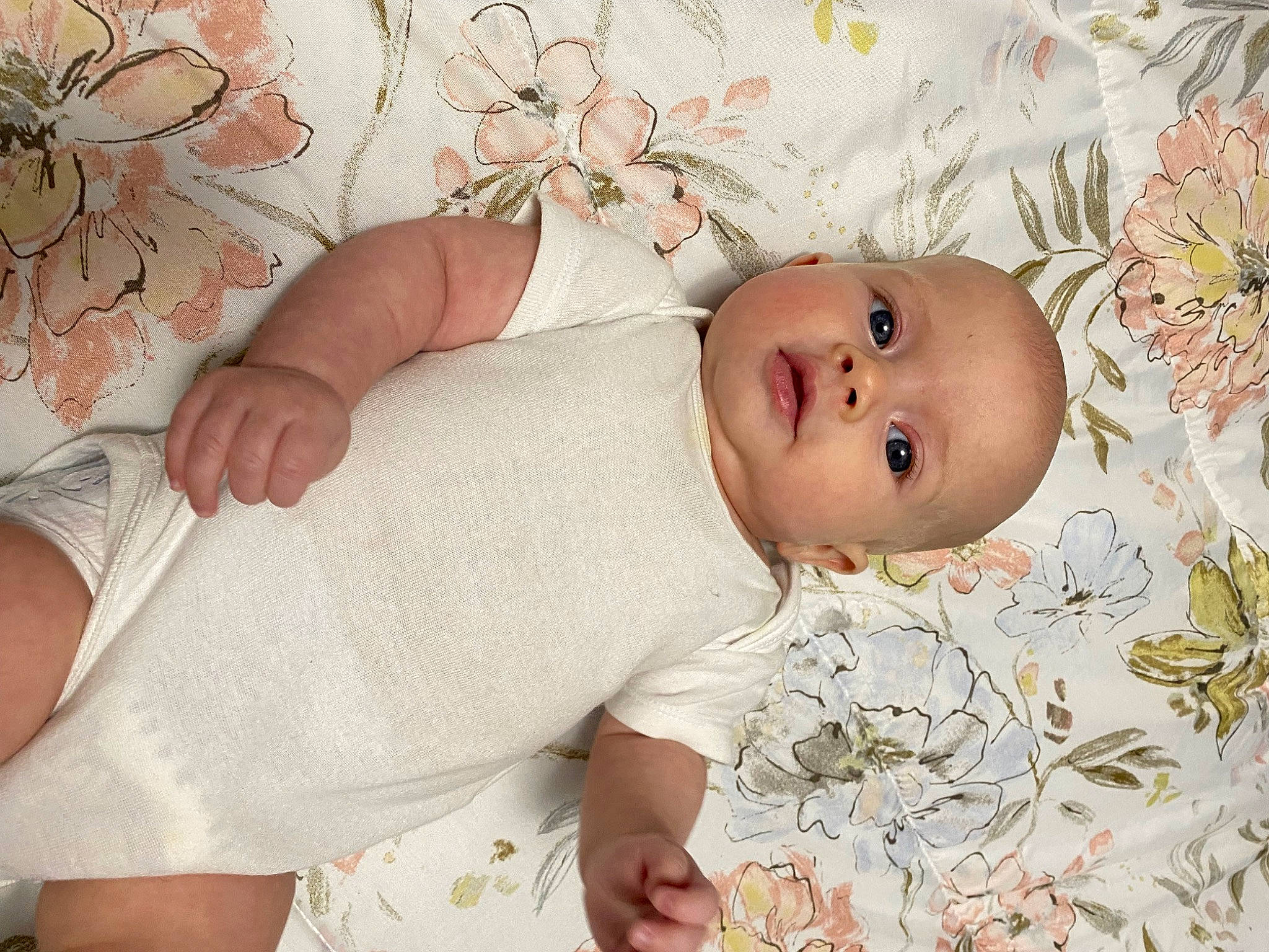 Madilyn is registered to the contest to win money with this photo: baby, baby_products, baby_safety, baby_sleeping, baby_toddler_clothing, bedding, cheek, child, comfort, fashion_accessory, flower, hair_accessory, happy, linens, pattern, peach, person, pink, skin, sleeve