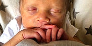 Theodore joined the competition — help win amazing prizes! newborn, baby, sleeping, hands, blanket, star_pattern, face, infant, cozy, soft_lighting, cute, peaceful, resting, child, portrait, skin, hair, closeup, indoors, comfort