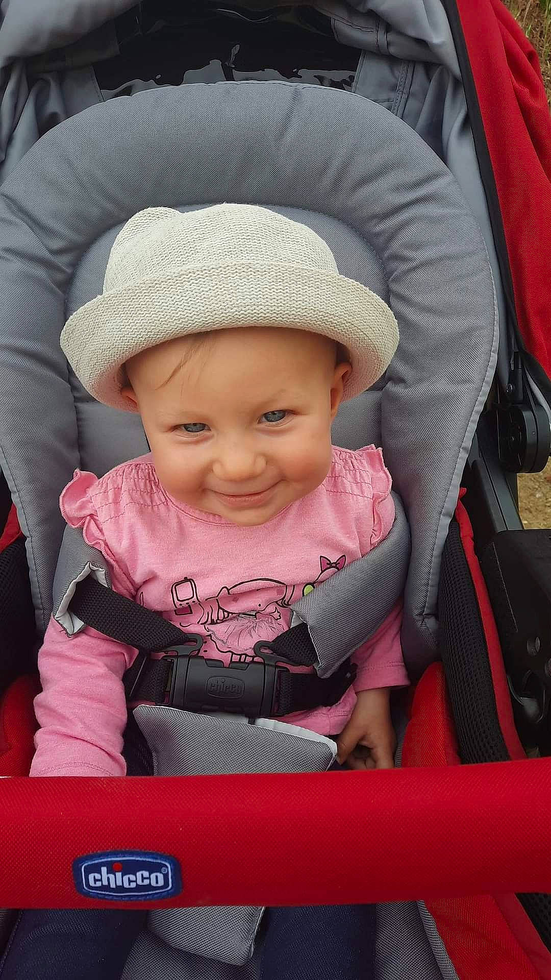 Thya a rejoint le concours — aidez-le/la à gagner de superbes lots ! auto_part, baby, baby_carriage, baby_products, baby_toddler_clothing, cap, car_seat, cheek, child, comfort, fashion_accessory, happy, hat, headwear, joy, magenta, person, pink, product, sitting