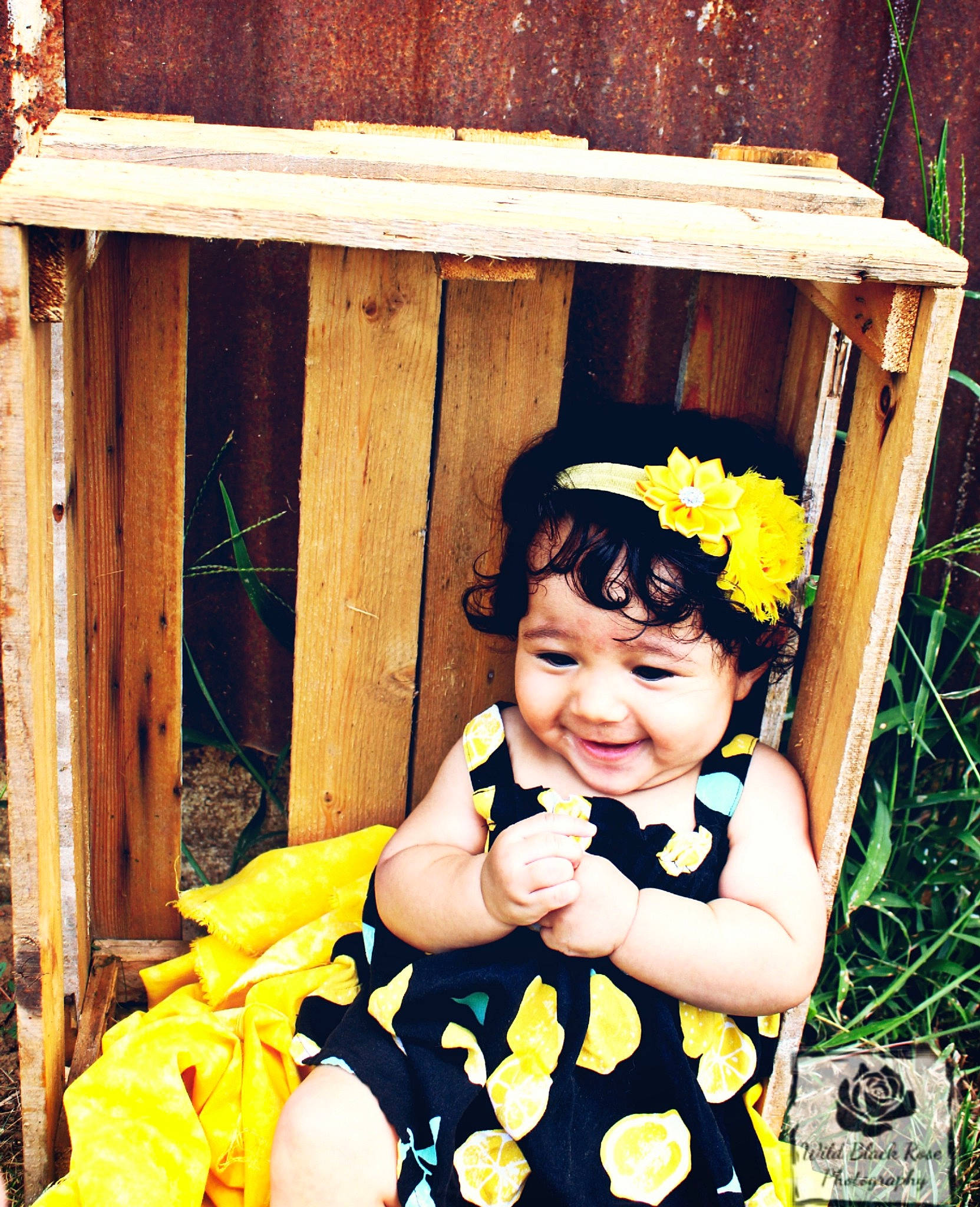 Kennedi is registered to the contest to win money with this photo: baby, baby_products, baby_toddler_clothing, black_hair, child, eye, facial_expression, flash_photography, fun, grass, green, hairstyle, happy, joy, people_in_nature, person, play, sitting, smile, toddler