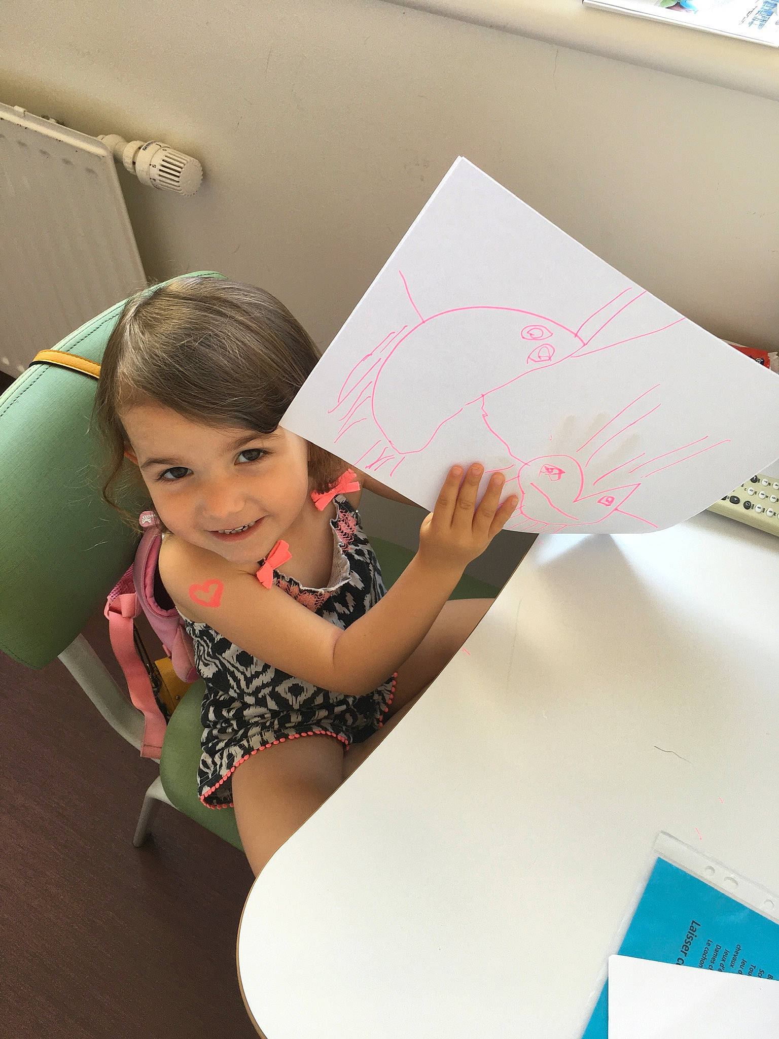 Olivia participe au concours pour gagner de l'argent avec cette photo : art, automotive_design, child, fashion_design, finger, flooring, font, fun, happy, human, joy, leisure, paper, paper_product, person, pink, room, smile, stationery, t_shirt