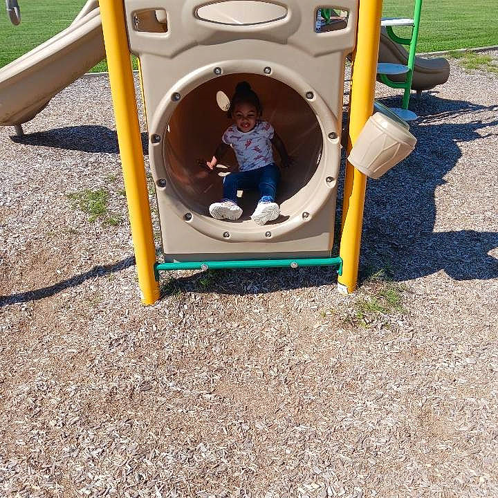 Andrella Grace is registered to the contest to win money with this photo: baby_toddler_clothing, chair, chute, city, comfort, fun, grass, leisure, motor_vehicle, outdoor_play_equipment, person, plant, play, playground, recreation, shade, soil, toddler, tree