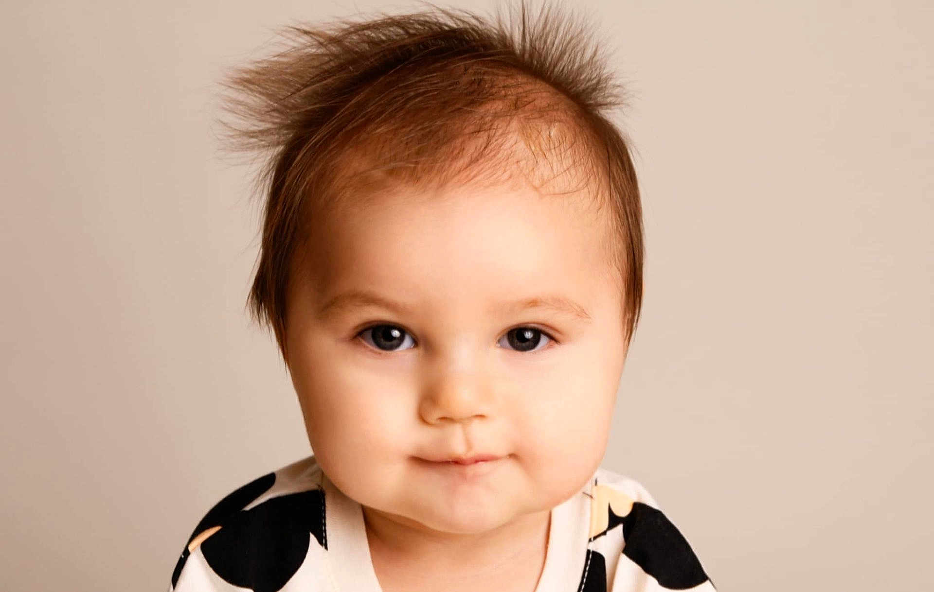 Koda joined the competition — help win amazing prizes! baby, child, portrait, face, smile, hair, wild_hair, eyes, cute, infant, expression, close_up, clothing, patterned_outfit, indoor, soft_background, head, skin, person, young_child