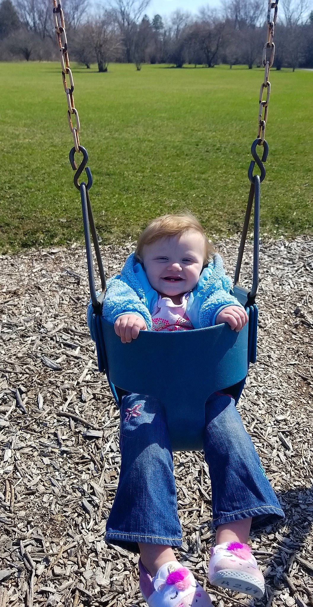 Ryleigh joined the competition — help win amazing prizes! arm, baby, black, blue, eye, face, grass, green, happy, head, human_body, jeans, joy, people_in_nature, person, photograph, plant, playground, smile, swing